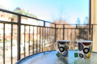 two coffee cups sitting on top of a glass table at Apartman Saga Premium Garaza Parking Vauceri Ne in Soko Banja