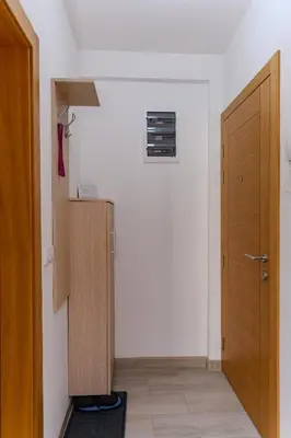 a room with a closet and a door and a hallway at Apartman Saga Premium Garaza Parking Vauceri Ne in Soko Banja