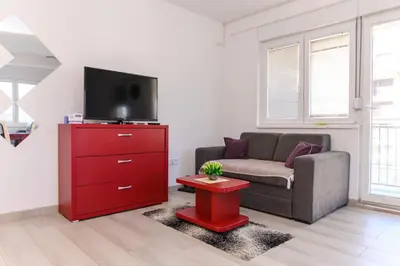 a living room with a couch and a red dresser at Apartman Saga Premium Garaza Parking Vauceri Ne in Soko Banja
