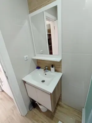 a bathroom with a sink and a mirror at Dvori E11 Hilltop in Kopaonik