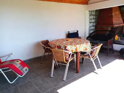 a table and chairs in a room at Apartmani Ćosić in Kuršumlija