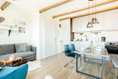 a living room with a couch and a table at Srebrna Petica in Kopaonik
