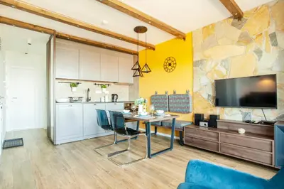 a kitchen and dining room with a table and a tv at Srebrna Petica in Kopaonik