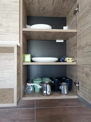 a cupboard with pots and pans and a plate at L18 apartment Milmari in Kopaonik