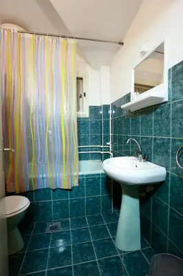 a bathroom with a sink and a shower curtain at Apartman Carpe Diem in Zaječar