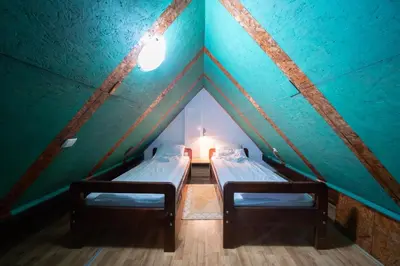 two beds in a room with a green ceiling at Planinske Vile M&S in Kopaonik