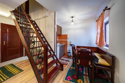 a room with a spiral staircase in a house at Planinske Vile M&S in Kopaonik