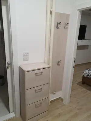 a room with a dresser and a closet with a mirror at Apartman Jankulovski in Kraljevo