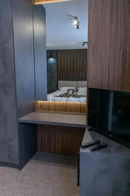 a bedroom with a bed and a large mirror at Prenoćište Binta in Vranje