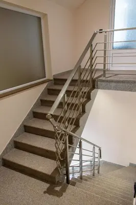 a staircase in a building with a metal railing at Prenoćište Binta in Vranje
