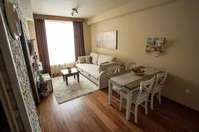 a living room with a table and a couch at Planinska bajka - Kraljevi čardaci in Kopaonik