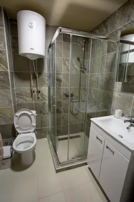 a bathroom with a shower and a toilet and a sink at Planinska bajka - Kraljevi čardaci in Kopaonik