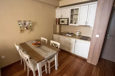 a kitchen and dining room with a table and chairs at Planinska bajka - Kraljevi čardaci in Kopaonik