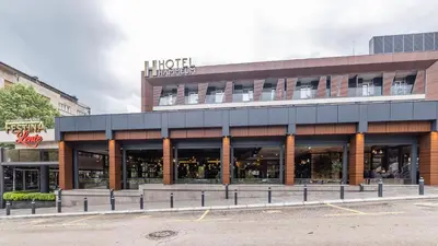 a store front of a building with a lot of windows at Hammeum Hotel in Prokuplje
