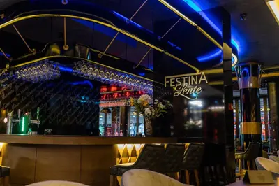 a bar at a restaurant with a neon sign at Hammeum Hotel in Prokuplje