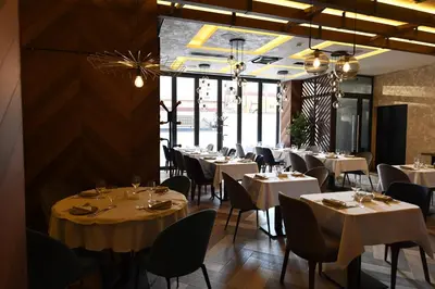 a dining room with white tables and chairs at Hammeum Hotel in Prokuplje