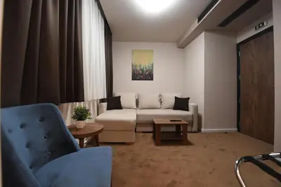 a living room with a couch and a table at Hammeum Hotel in Prokuplje