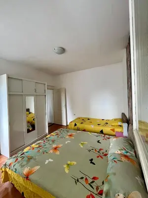 a bedroom with two beds and a mirror at apartman centar S in Pirot