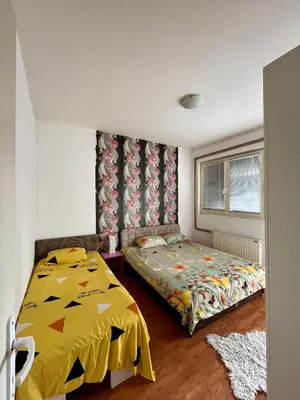 a bedroom with a bed with a yellow comforter at apartman centar S in Pirot