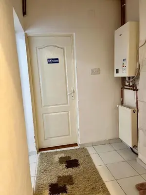 a white door with a sticker on it in a kitchen at apartman centar S in Pirot