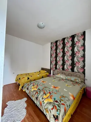 a bedroom with a bed with a colorful comforter at apartman centar S in Pirot