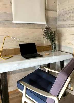 a desk with a laptop computer on top of it at Kostovac Boutique Homes - Sauna in Kopaonik