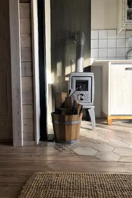 a kitchen with a stove in a room with a floor at Kostovac Boutique Homes - Sauna in Kopaonik