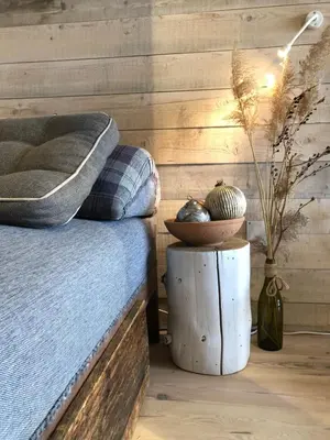 a bedroom with a bed and a wooden wall at Kostovac Boutique Homes - Sauna in Kopaonik