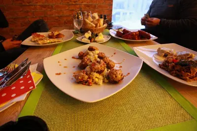 a table with plates of food on top at Apartman BIG Milmari S19 in Kopaonik