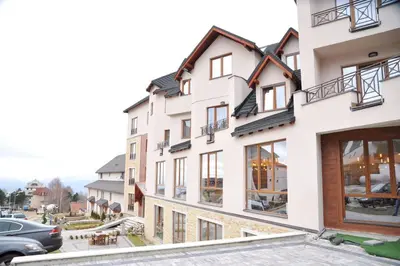 a large white building with large windows at Apartman BIG Milmari S19 in Kopaonik