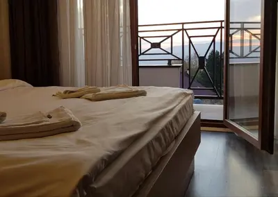 a bedroom with two beds and a large window at Premier 29 Milmari Resort Wellness&Spa in Kopaonik