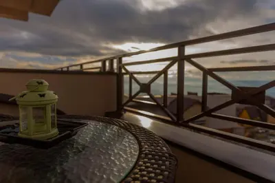 a candle sitting on a table on a balcony at Premier 29 Milmari Resort Wellness&Spa in Kopaonik
