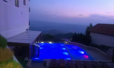 a swimming pool with blue lighting at night at Premier 29 Milmari Resort Wellness&Spa in Kopaonik
