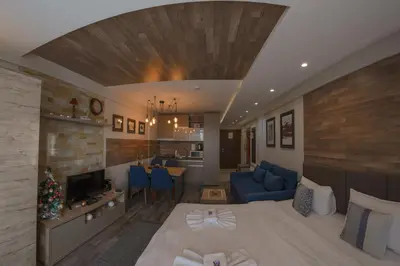 a room with a bed and a living room at Premier 29 Milmari Resort Wellness&Spa in Kopaonik