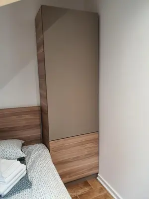 a bedroom with two beds and a wall at Vila Plan centar Kopaonik in Kopaonik