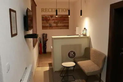 a small room with a chair and a table at Vila Lucky Kop & Restoran in Kopaonik