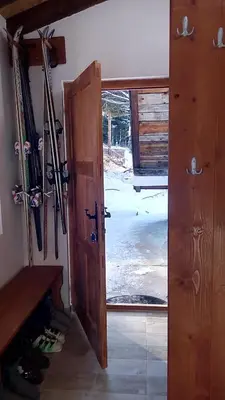 an open door to a room with skis on the wall at Sky 3 in Kopaonik