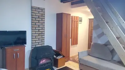 a living room with a stove and a tv at Sky 3 in Kopaonik