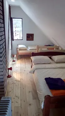 a bedroom with three beds and a window at Sky 3 in Kopaonik