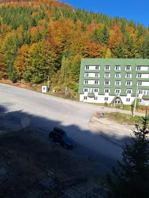 a car parked on a road in front of a building at Vila Košuta - Kopaonik, Brzeće 30m from gondola in Brzeće