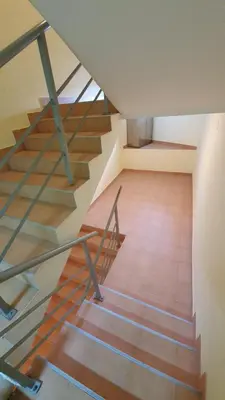 a staircase in a house with a wooden floor at Vila Košuta - Kopaonik, Brzeće 30m from gondola in Brzeće