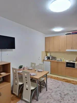 a kitchen and dining room with a table and chairs at Vila Košuta - Kopaonik, Brzeće 30m from gondola in Brzeće