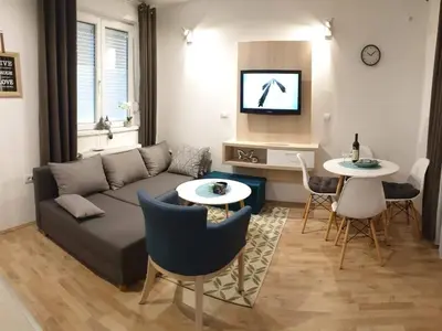 a living room with a couch and a table at Apartman Beker Vrnjacka Banja in Vrnjačka Banja