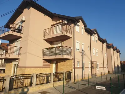 a building with balconies on the side of it at Apartman Beker Vrnjacka Banja in Vrnjačka Banja