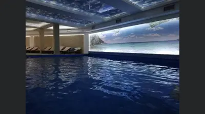 a room with a swimming pool with a view of the ocean at Apartment Sunny Valley Milmari S-9 in Kopaonik