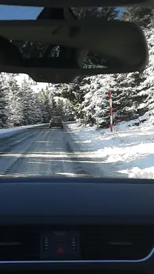 a car driving down a road in the snow at Apartment Sunny Valley Milmari S-9 in Kopaonik