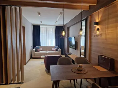 a living room with a couch and a table at Select Lux Woodside Residences & SPA in Kopaonik