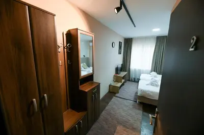 a hotel room with a bed and a mirror at Corner Apartmani in Leskovac