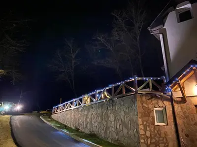 a bridge with lights on the side of a road at night at Kuca za odmor ,,Balkan” in Crni Vrh