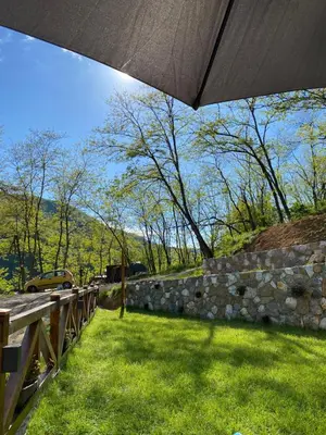 a view of a stone wall with an umbrella at Kuca za odmor ,,Balkan” in Crni Vrh